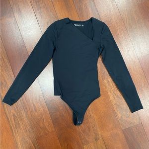 Asymmetrical long sleeve body suit
